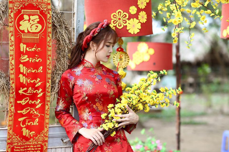 Tư thế chụp ảnh áo dài cùng cành hoa chào Tết Nguyên Đán